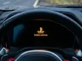 Kontrolka płynu chłodniczego BMW E46 świeci się na pomarańczowo, informując o niskim poziomie płynu.