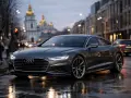 Elegancki Audi A9 na mokrej ulicy miasta, z odbiciami świateł i złotymi kopułami cerkwi w tle.